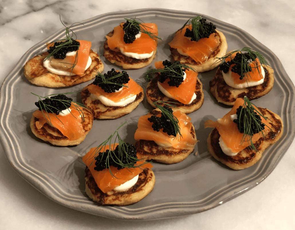 A plate of smoked salmon and caviar blini, a type of Russian pancakes